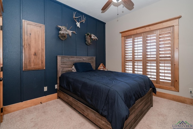 carpeted bedroom featuring baseboards and ceiling fan
