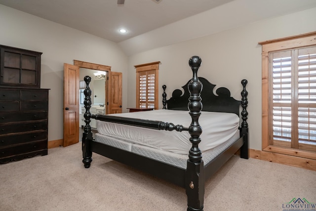 bedroom featuring baseboards, light colored carpet, multiple windows, and lofted ceiling