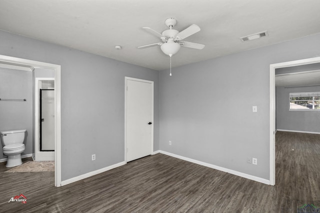 unfurnished bedroom with connected bathroom, ceiling fan, and dark hardwood / wood-style flooring