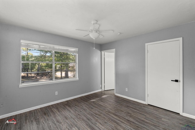 spare room with ceiling fan and dark wood-type flooring