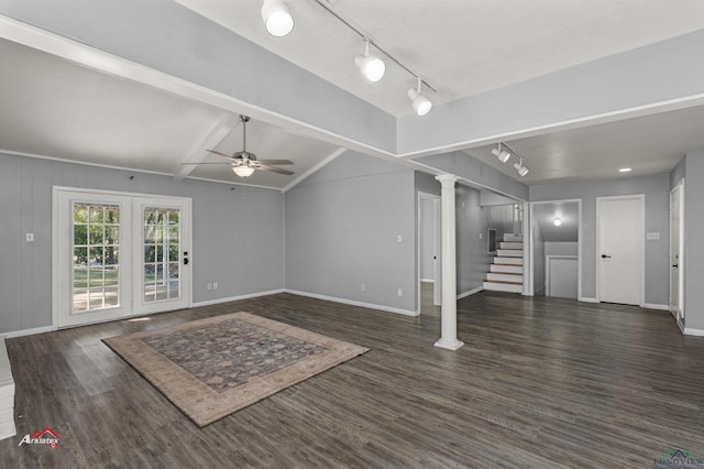 unfurnished living room with rail lighting, ceiling fan, and dark wood-type flooring