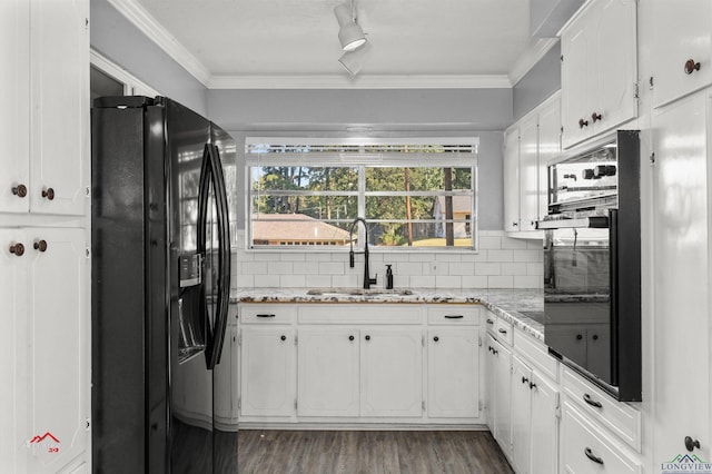 kitchen with black appliances, white cabinets, sink, decorative backsplash, and ornamental molding