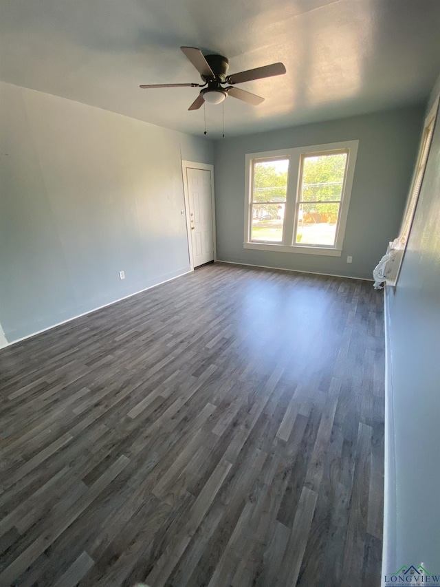 spare room with ceiling fan and dark hardwood / wood-style flooring