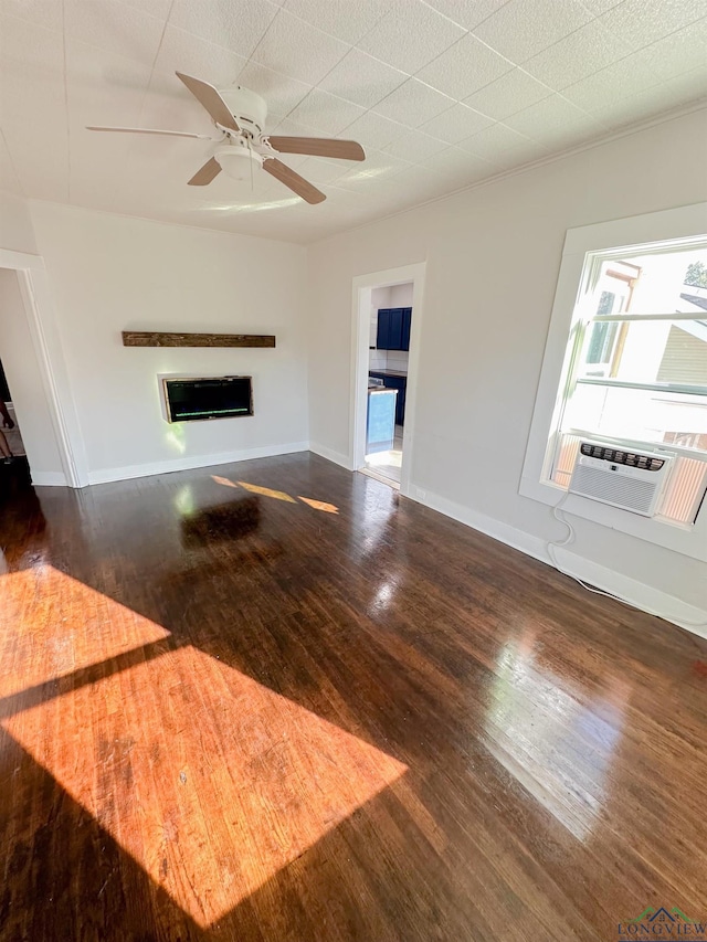 unfurnished living room featuring cooling unit, ceiling fan, and dark wood-type flooring