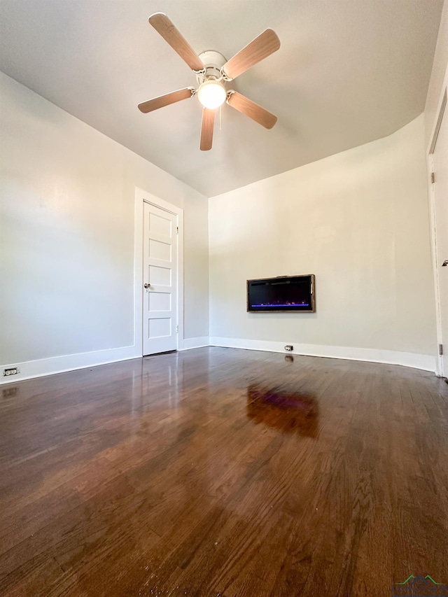 unfurnished living room featuring dark hardwood / wood-style floors and ceiling fan