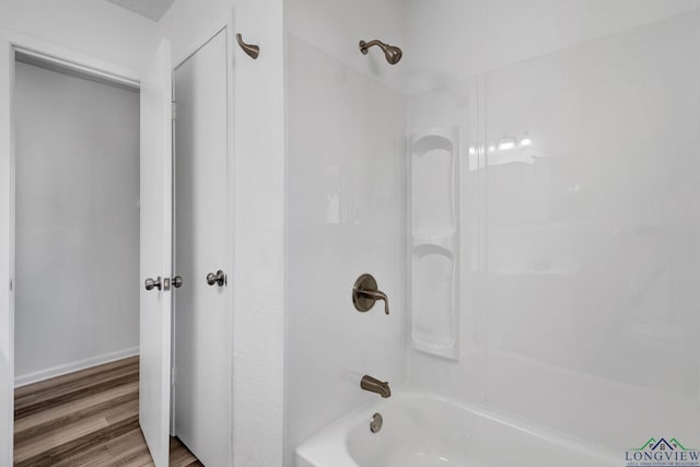 bathroom featuring hardwood / wood-style flooring and bathtub / shower combination