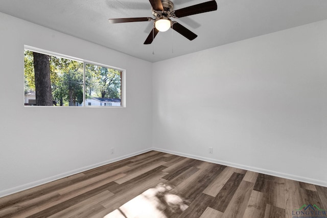 empty room with ceiling fan and hardwood / wood-style flooring