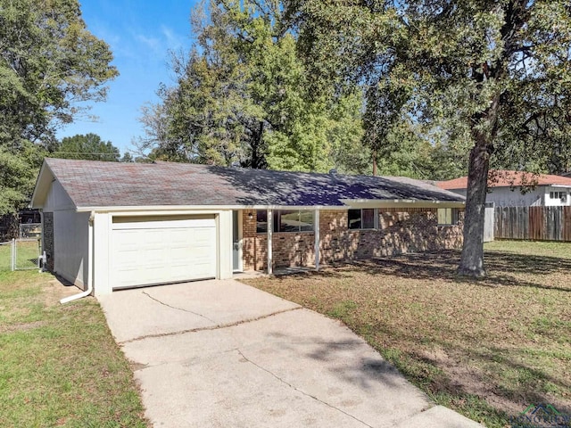 single story home featuring a front yard and a garage