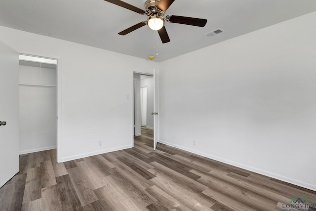 unfurnished bedroom featuring a closet, hardwood / wood-style flooring, and ceiling fan