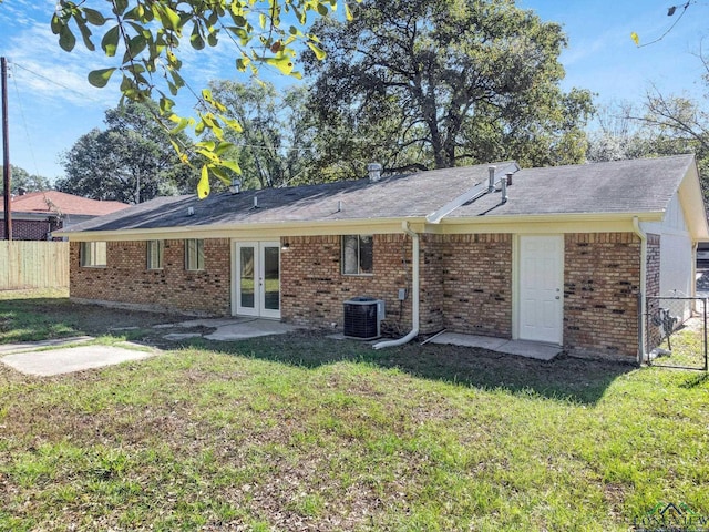 back of house featuring a yard, french doors, and cooling unit