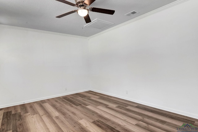 spare room featuring ceiling fan, wood-type flooring, a textured ceiling, and ornamental molding