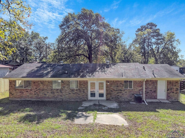 back of property featuring french doors, a yard, and central air condition unit