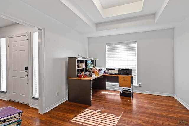 office space with dark hardwood / wood-style floors and a raised ceiling