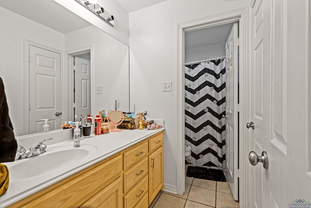 bathroom featuring tile patterned floors, walk in shower, vanity, and toilet