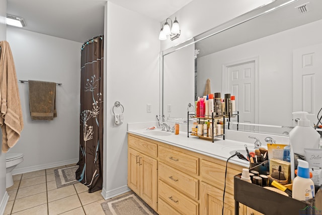 bathroom with tile patterned floors, vanity, and toilet