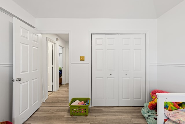 bedroom with light wood-type flooring and a closet