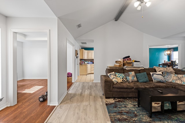 living room with lofted ceiling with beams, light hardwood / wood-style flooring, and ceiling fan