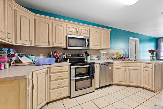 kitchen with sink, light tile patterned floors, stainless steel appliances, and light brown cabinetry