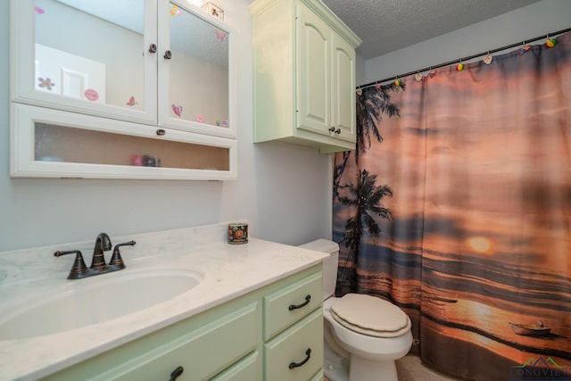 bathroom featuring vanity, a textured ceiling, and toilet