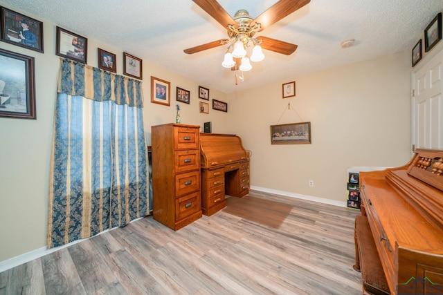 miscellaneous room with a textured ceiling, light hardwood / wood-style flooring, and ceiling fan