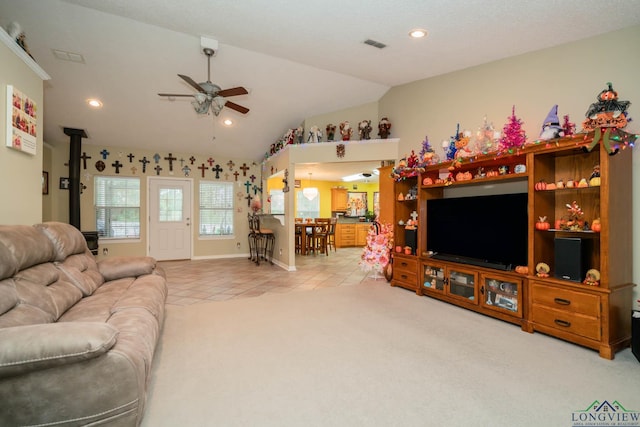 living room with light tile patterned floors, ceiling fan, and lofted ceiling