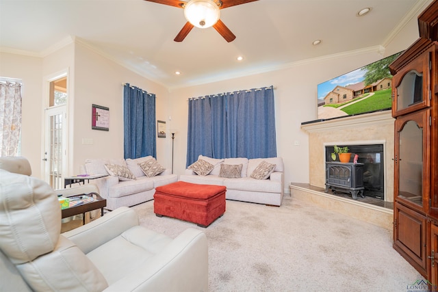 2120 Page Rd, Longview, TX 75601 - living room featuring a wood stove, ceiling fan, carpet floors, crown molding, and recessed lighting