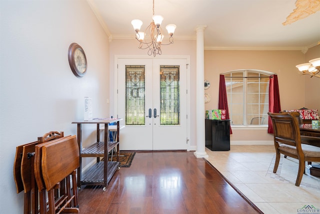 2120 Page Rd, Longview, TX 75601 - foyer entrance with a chandelier, french doors, crown molding, wood finished floors, and decorative columns