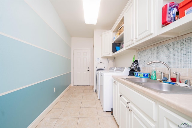 2120 Page Rd, Longview, TX 75601 - washroom featuring a sink, light tile patterned floors, and separate washer and dryer