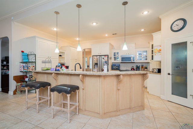 2120 Page Rd, Longview, TX 75601 - kitchen with stainless steel appliances, light tile patterned flooring, a kitchen bar, ornamental molding, and light stone countertops