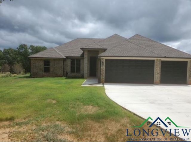 view of front of home featuring a garage and a front lawn