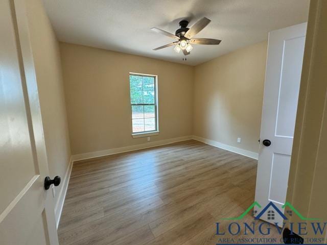 unfurnished room with ceiling fan and light wood-type flooring