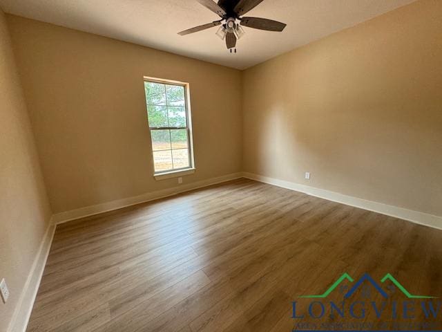 empty room with ceiling fan and hardwood / wood-style floors