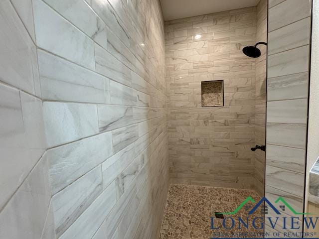 bathroom with tiled shower