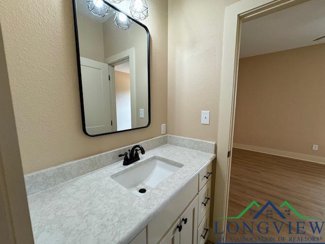 bathroom with vanity and wood-type flooring