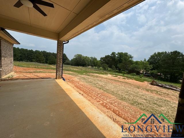 view of yard with a patio and ceiling fan