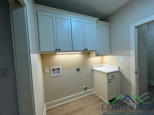 washroom with hookup for a washing machine, light hardwood / wood-style flooring, cabinets, and hookup for an electric dryer