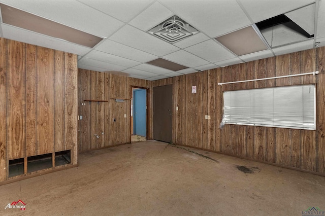 707 Willow St, Carthage, TX 75633 - unfurnished room featuring wooden walls and a drop ceiling