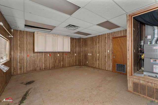 707 Willow St, Carthage, TX 75633 - finished basement with wooden walls and a drop ceiling