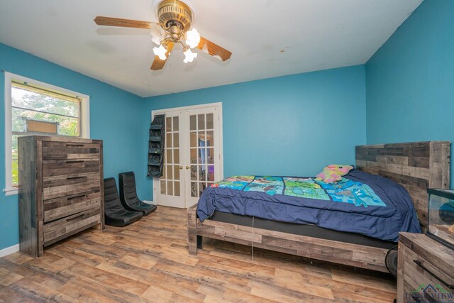 10816 Fm 2685, Gladewater, TX 75647 - bedroom featuring french doors, wood finished floors, and a ceiling fan