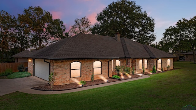 view of front of property featuring a yard and a garage