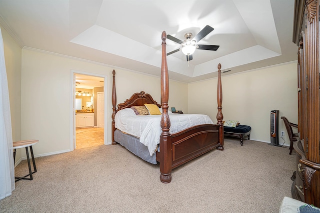 carpeted bedroom featuring connected bathroom, a raised ceiling, ceiling fan, and crown molding