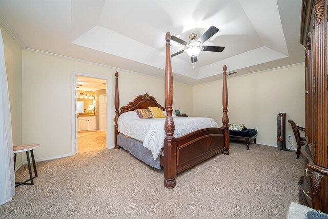 carpeted bedroom featuring connected bathroom, a raised ceiling, ceiling fan, and crown molding