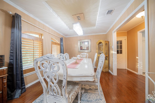 dining space featuring dark hardwood / wood-style floors and crown molding