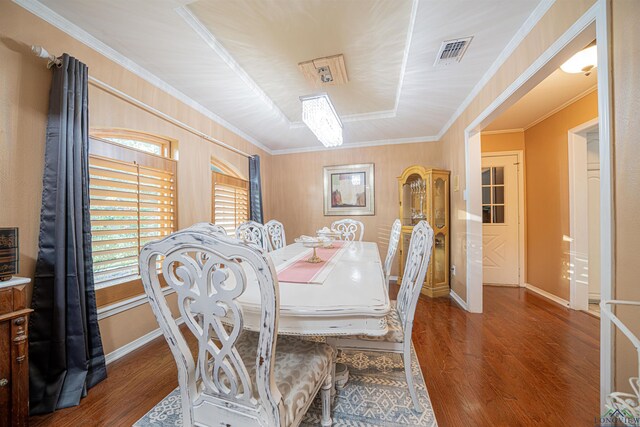 dining space featuring dark hardwood / wood-style floors and crown molding