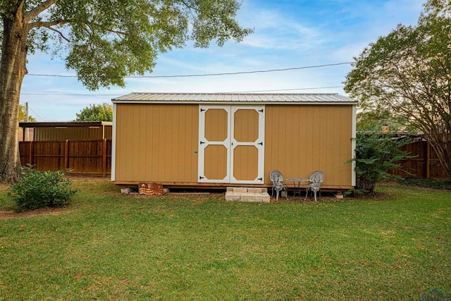 view of outdoor structure featuring a lawn