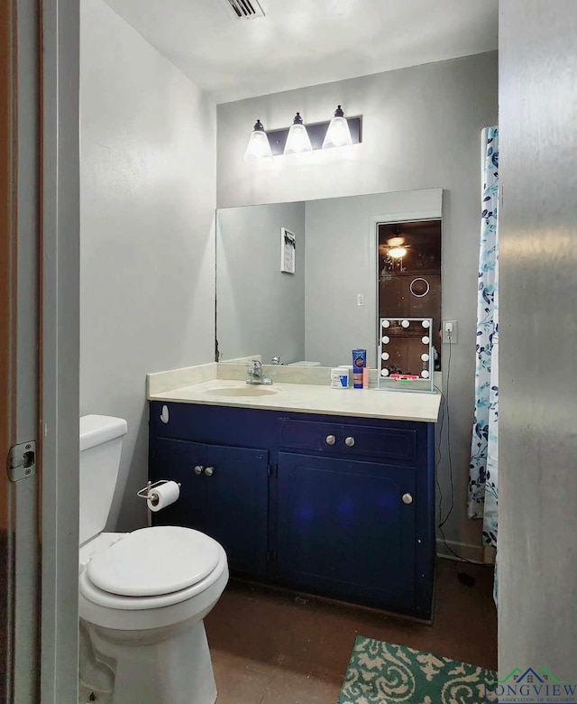 bathroom featuring vanity and toilet