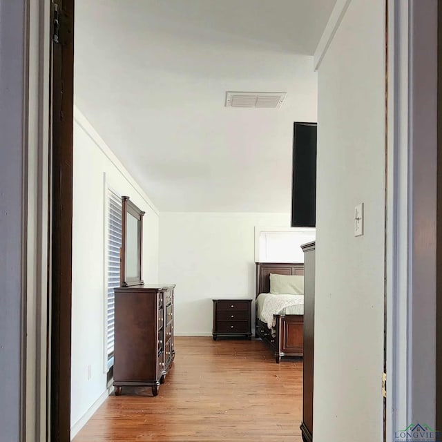 corridor with light hardwood / wood-style floors