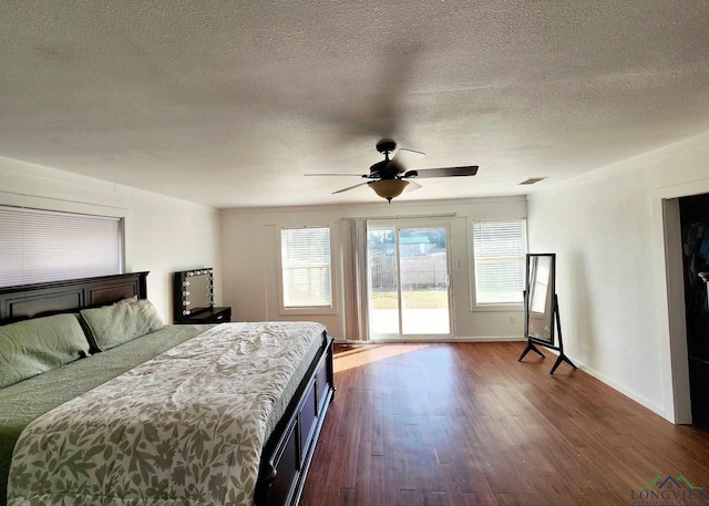 unfurnished bedroom featuring ceiling fan, access to outside, dark hardwood / wood-style floors, and a textured ceiling