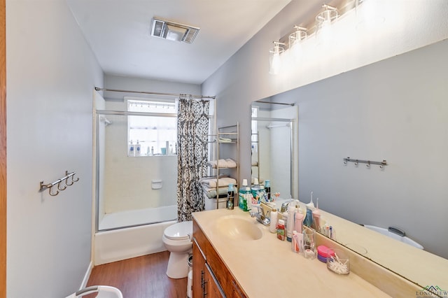 full bathroom with toilet, wood-type flooring, vanity, and shower / bath combo with shower curtain