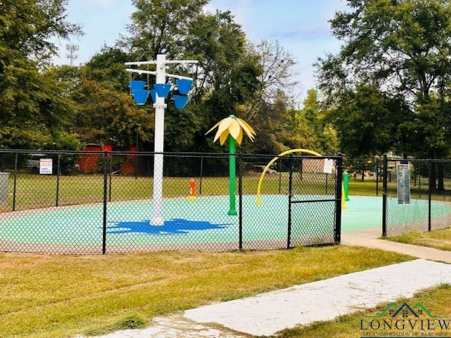 view of basketball court with a yard